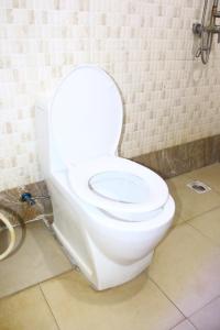 a bathroom with a white toilet in a room at Rungwe Hotel in Dar es Salaam