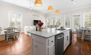 a kitchen and living room with a table and chairs at Inlet Breeze in Inlet Beach