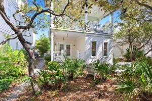 a white house with a balcony on top of it at Inlet Breeze in Inlet Beach