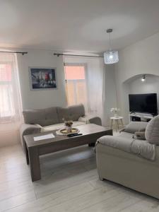 a living room with a couch and a table at Apartmán 6- Self check-in in Spišské Podhradie