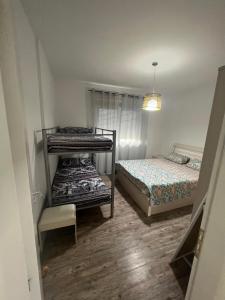 a bedroom with two bunk beds and a window at Sea view in Durrës