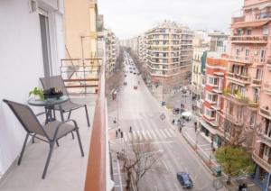 a balcony with a table and a city street at Prime location - 2 bd Boutique apartment in Thessaloniki