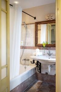 a bathroom with a sink and a tub and a mirror at Son Sant Jordi in Pollença