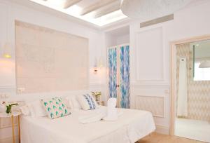 a white room with a bed with pillows on it at Son Sant Jordi in Pollença