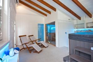a bathroom with two chairs and a bath tub at Son Sant Jordi in Pollença
