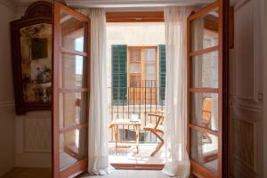 an open window with a view of a balcony at Son Sant Jordi in Pollença