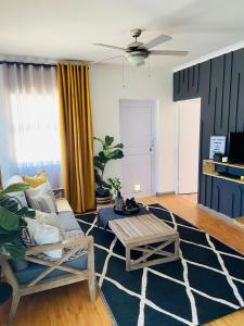 a living room with a couch and a table at Cottage by Design, Somerset West in Somerset West