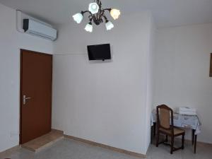 a room with a door and a tv on the wall at Lucazione Turistica in Mestre