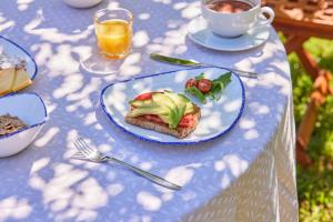 a blue table with a plate of food on it at Son Sant Jordi in Pollença