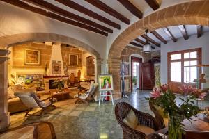 a living room with a couch and a table and chairs at Son Sant Jordi in Pollença