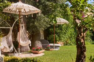 two hammocks and two umbrellas in a garden at Son Sant Jordi in Pollença