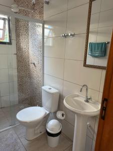a bathroom with a toilet and a sink at Pousada ENCANTOS DO MAR in Ubatuba