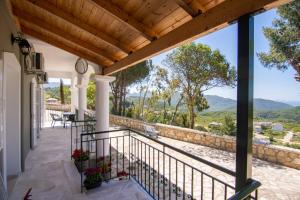 a balcony with a view of the mountains at Sea and mountain hotel in Perdika