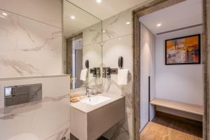 a bathroom with a sink and a shower at Effotel by Sayaji Navi Mumbai in Navi Mumbai +47 photos
