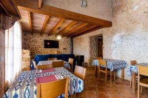 a restaurant with tables and chairs in a room at YourHouse Agroturismo Can Porreti Sa Rota in Lloret de Vistalegre