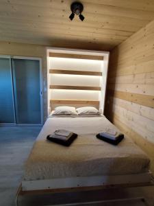 a bedroom with a bed with two towels on it at Woodstudio in Gaujacq +17 photos