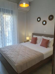 a bedroom with a large bed with white sheets and red pillows at Villa Modern Nikiti in Nikiti