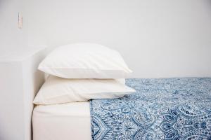 a pile of pillows sitting on top of a bed at Stefanie Studios in Egina