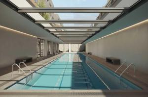 a large swimming pool with a glass ceiling at Studio Home Madrid in San Sebastián de los Reyes