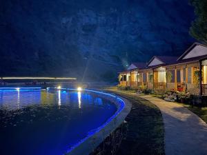 a house with a swimming pool at night at Dream Nest Resorts in Skardu