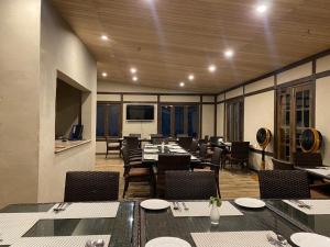 a dining room with tables and chairs in a room at Dream Nest Resorts in Skardu