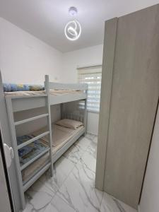 a room with two bunk beds and a window at Villa Sole in Shkodër
