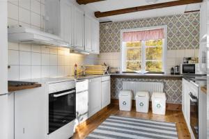 a kitchen with white appliances and a window at Grimsnas Herrgard in Ljuder