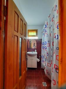 a bathroom with a sink and a shower curtain at Cabana Livada Merilor in Băile Govora +39 photos