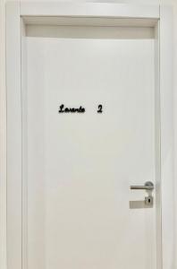 a white door with the word escape written on it at Guest House Levante in Porto Torres +16 photos