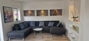 a living room with a couch and a stool at Cozy Villa in Rødby +1 photo