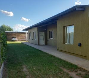 a house with a garage and a grass yard at Departamentos Capernaum in Santa Rosa