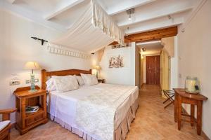 a bedroom with a large white bed in a room at Casa Son Sant Jordi in Pollença