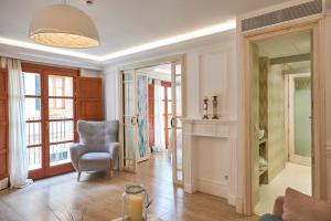a living room with a chair and a window at Son Sant Jordi in Pollença
