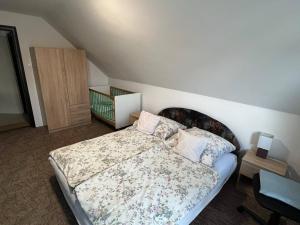 A bed or beds in a room at Talabér Vendégház