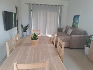 a living room with a table and chairs and a couch at Evasion Maragon in Saint Gabriel