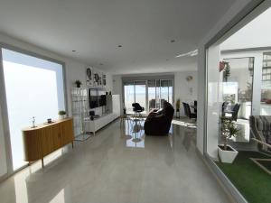 a living room with a couch and a chair in a room at La terraza de la Jaca in Arico