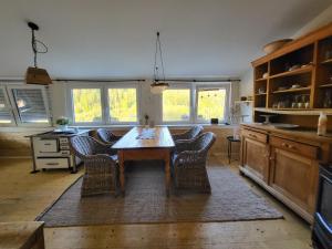 a kitchen with a wooden table and chairs at Ferienwohnung Schwarzwaldglück in Baiersbronn
