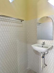 a bathroom with a sink and a mirror at OSA Guest House in Seminyak