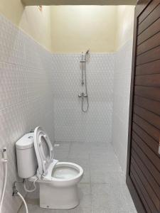 a bathroom with a toilet and a shower at OSA Guest House in Seminyak