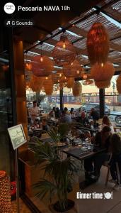 a restaurant with people sitting at tables at Apartament modern 2 camere,complet utilat,cu balcon si Vedere la mare-Zoorba in Mamaia Nord +28 photos