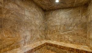 a large bathroom with a stone wall at Plantation Palms 6103 in Gulf Highlands
