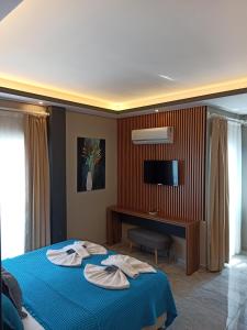 a bedroom with a blue bed with two plates on it at Başar hotel in Erdemli