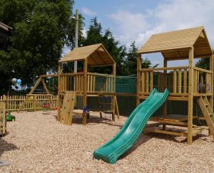 a wooden playground with a slide and a gazebo at Garway Moon Inn in Garway