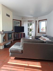 a living room with a couch and a television at Mon petit château in Pajay +16 photos
