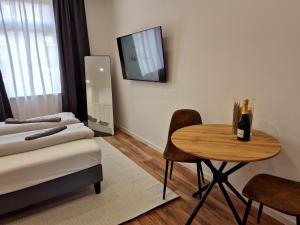 a room with a table and a bed and a mirror at Süße Marie 17 in Karlsruhe