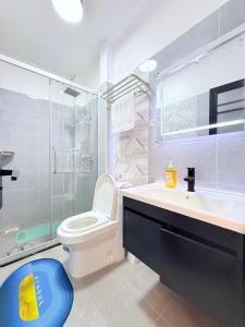 a bathroom with a toilet and a sink and a shower at Amari Suites in Gatunga