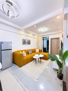 a living room with a yellow couch and a table at Amari Suites in Gatunga +7 photos