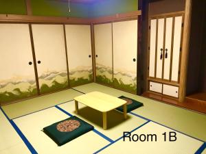 a room with a table and a room with a mountain mural at Otaruya, Kitchen, Living Room, NETFLIX, 2 Rooms, Max 7PP, Free Parking in Otaru