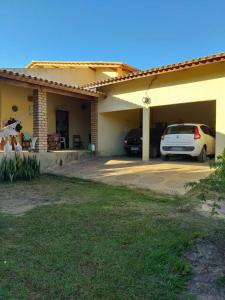 a house with two cars parked in a driveway at Casa em Rio de Contas in Rio de Contas +2 photos