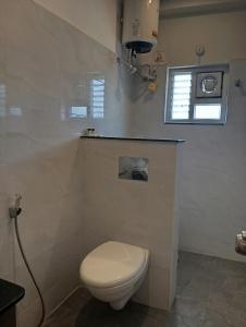a bathroom with a white toilet and a window at Embassy Suites in Hyderabad +30 photos